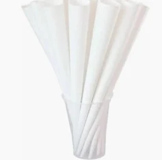 Eight shirts arranged on table in black, olive, grey, blue, white, red, mustard, and green.