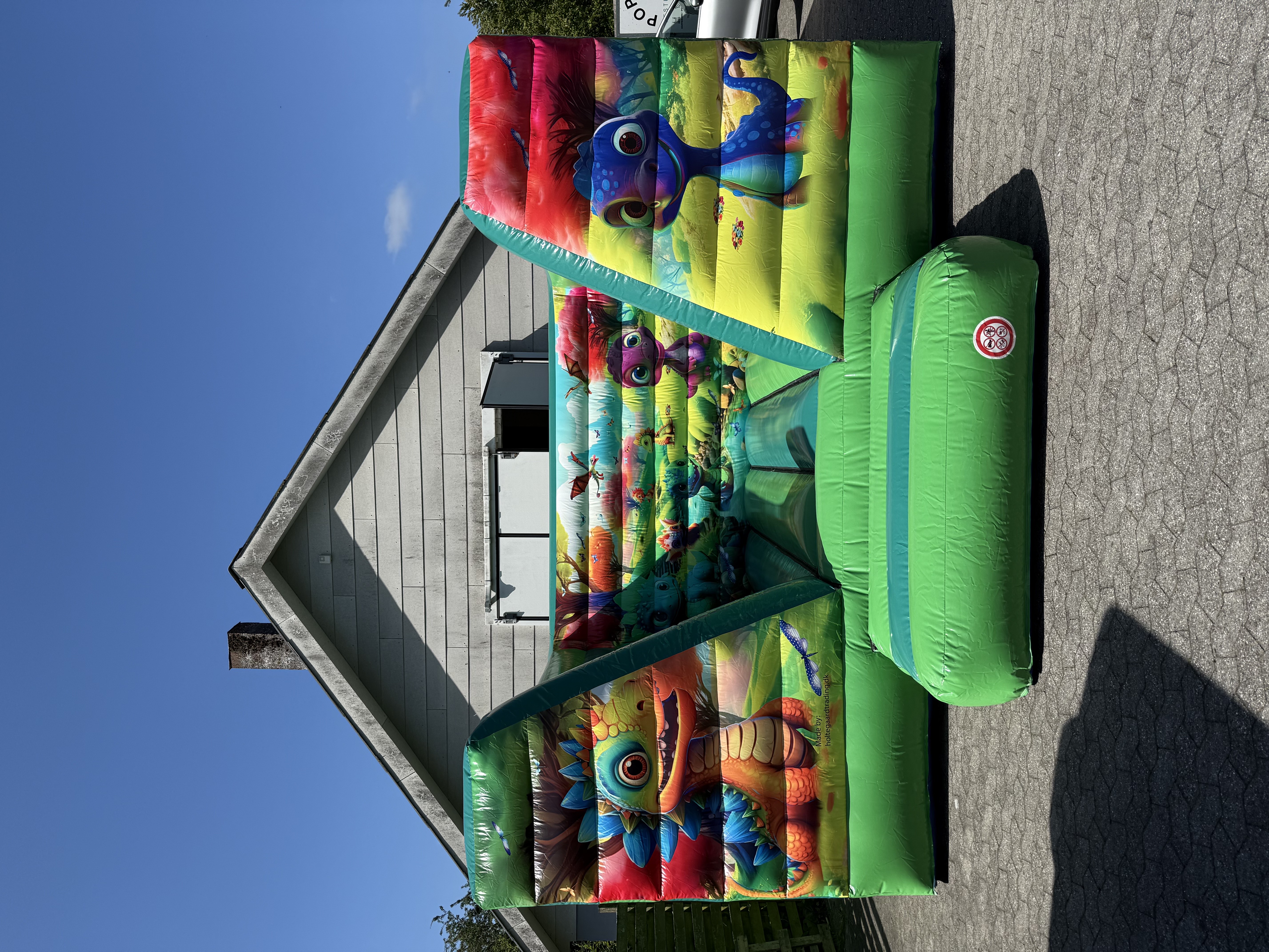 Eight shirts arranged on table in black, olive, grey, blue, white, red, mustard, and green.